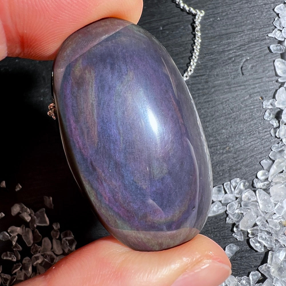 Dieser Regenbogenobsidian Anhänger ist ein echter Hingucker! Seine tiefschwarze Farbe wird von faszinierenden Regenbogenschimmern durchzogen. | Happy Minerals