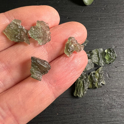 Mini Moldavit Besednice auf Fingern – winzige Tektite aus Tschechien | Happy Minerals
