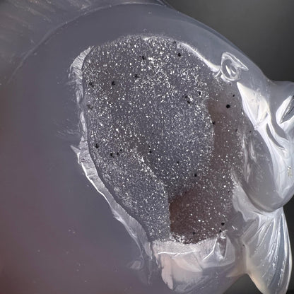 Makroaufnahme Achat Druzy Kristalle mit schwarzen Mineraleinschluessen