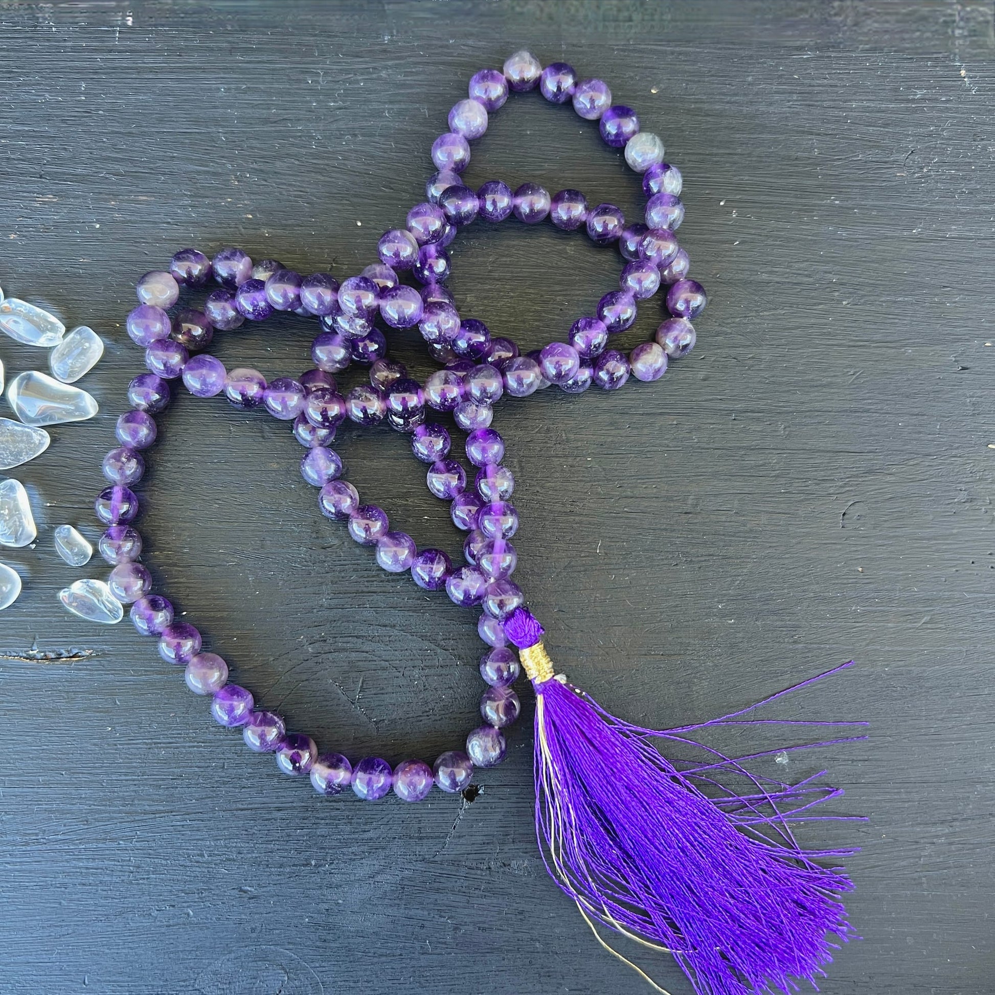 Amethyst Mala 108 Perlen | auf dunklem Holz drapiert | lila Quaste | Bergkristall | Indien | Happy Minerals