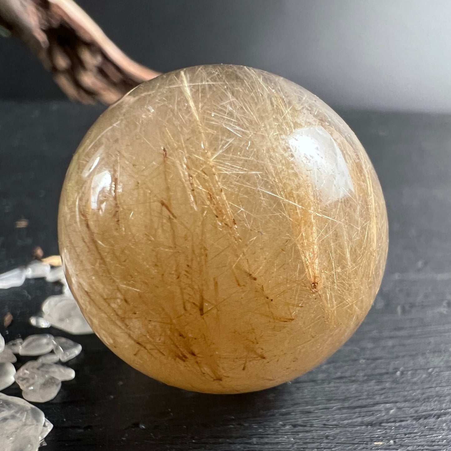 Goldrutilquarz Kugel | seitlich | intensive Rutileinschlüsse | Holzast Deko | Happy Minerals