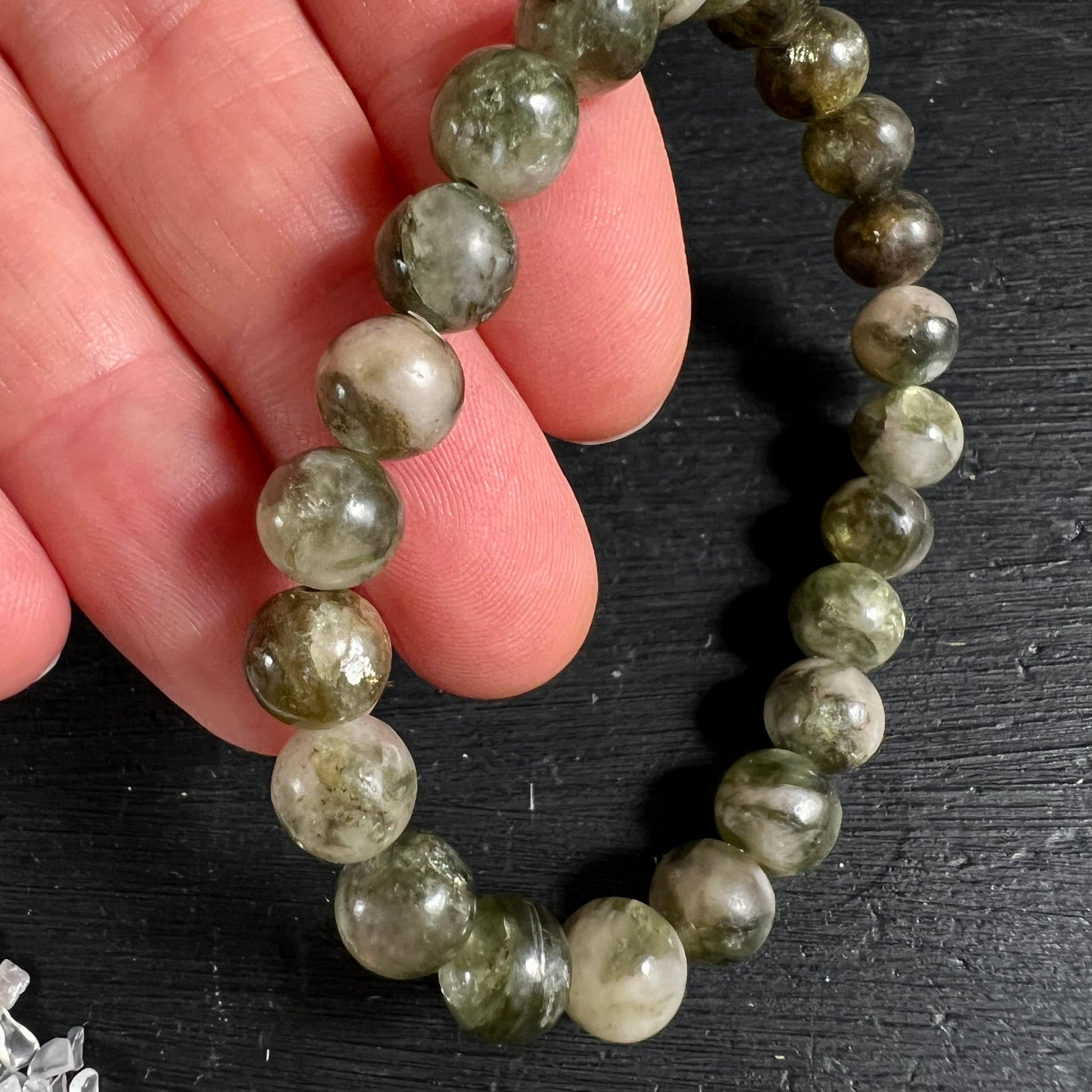 Grüner Lepidolith Armband Mali | Nahaufnahme Finger | blassgrün-olivfarbene Kugeln | lebendige Maserung | Happy Minerals
