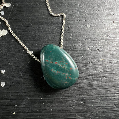 Heliotrop Blutstein | Seitenansicht | silberne Kette | schwarze Oberfläche | Tropfen | Happy Minerals