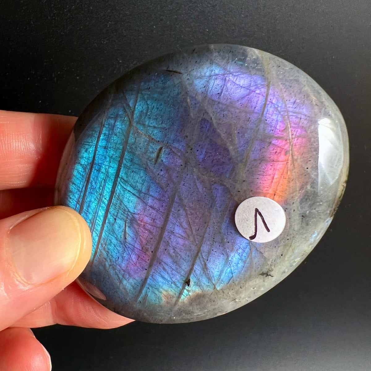 Labradorit Handschmeichler oval poliert, intensives Farbspiel: Türkis, Violett, Pink, Orange-Rot, dunkle Einschlusslinien | Happy Minerals