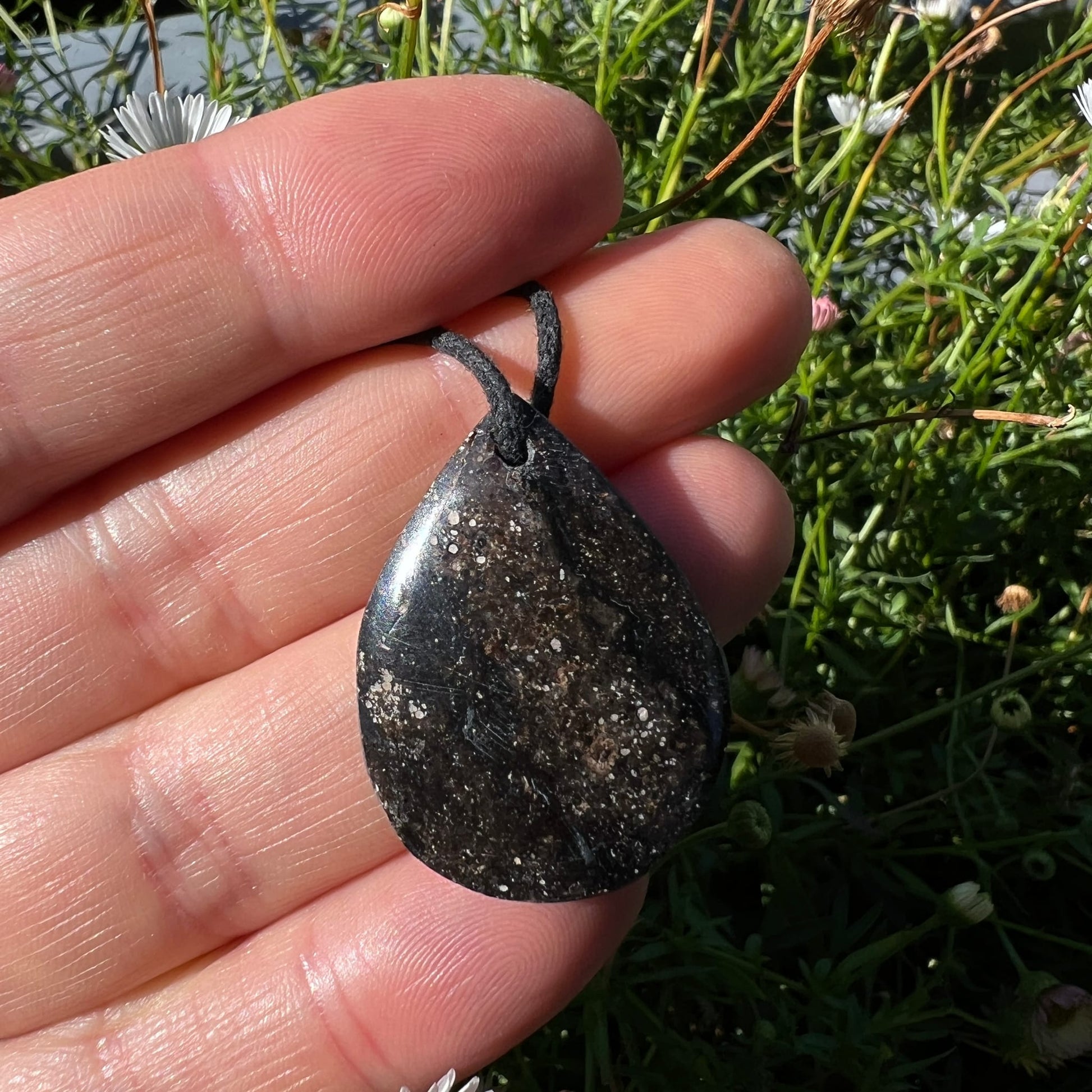 Mystischer Merlinit | Gesamtansicht Hand | erdige Brauntöne | schwarzes Band | Happy Minerals
