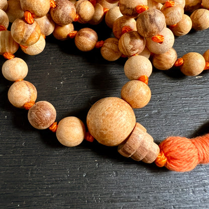 Palo Santo Mala | Nahaufnahme Guru Perle & Quaste | Maserung | orangefarbene Knoten | Happy Minerals