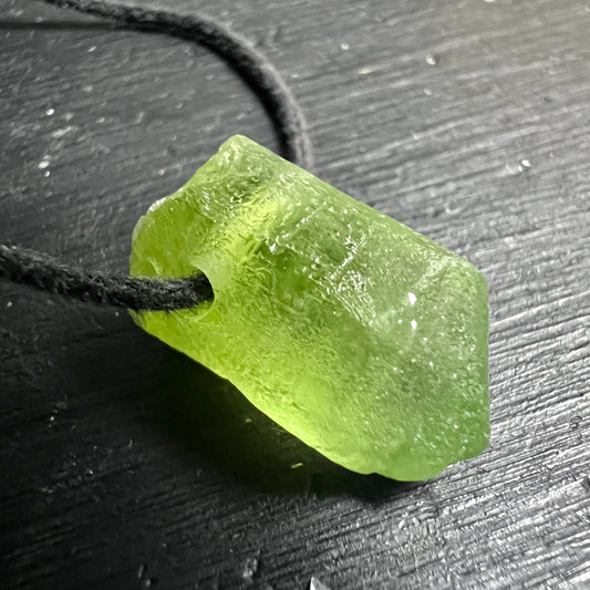 Peridot Olivin Rohstein, leuchtend gelbgrün, transparent mit rauer Oberfläche, rechteckig-roh, schwarze Kordel | Happy Minerals