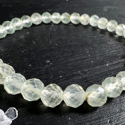 Prehnit Armband | Nahaufnahme halber Kreis | lindgrüne Facettierung | natürliche Einschlüsse sichtbar | Happy Minerals