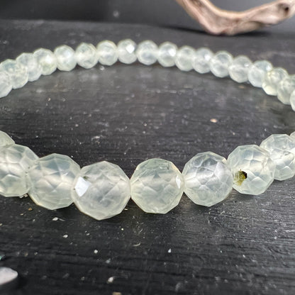 Prehnit Armband facettiert | Nahaufnahme | eisgrüne Facetten glänzen | natürliche Einschlüsse sichtbar | Happy Minerals