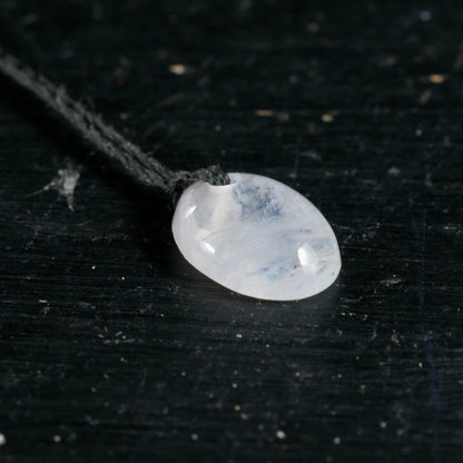 Mondstein Anhaenger oval poliert, milchig-weiss mit blauem Schimmer und Schlieren, an dunkler Kordel | Happy Minerals
