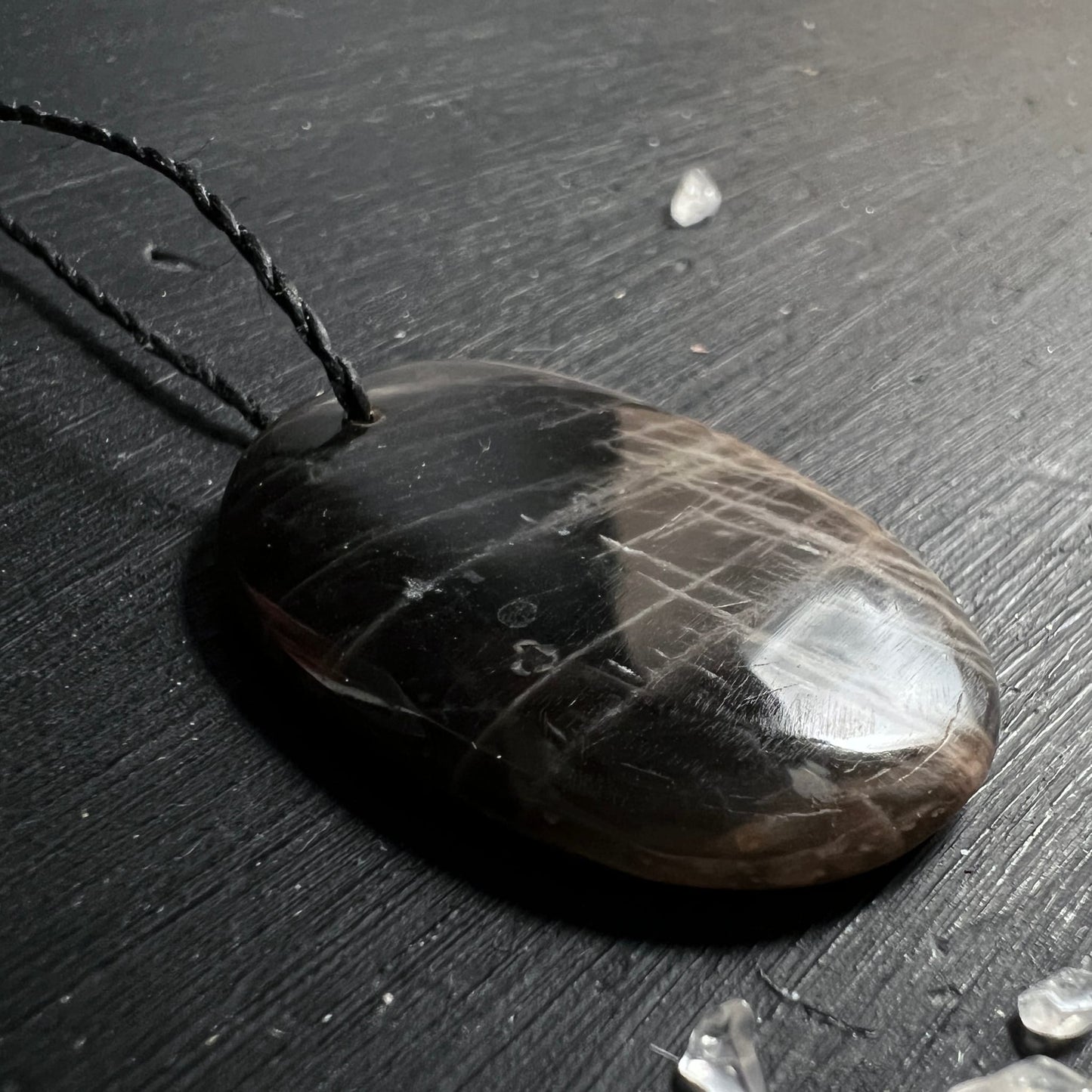 Schwarzer Mondstein Anhaenger oval poliert, dunkelbraun-schwarz mit hellbraunen Schlieren und starkem Glanz | Happy Minerals