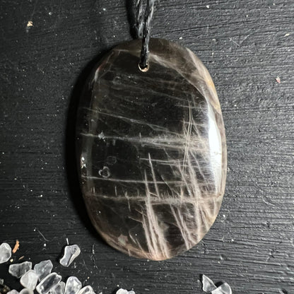 Schwarzer Mondstein Anhaenger oval poliert mit hellen Glanzstreifen und feinen Adern | Happy Minerals