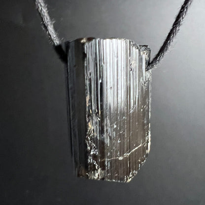 Schwarzer Turmalin | glänzende Rillen | freigestellt an Kette | silbrig schimmernd | Madagaskar | Happy Minerals