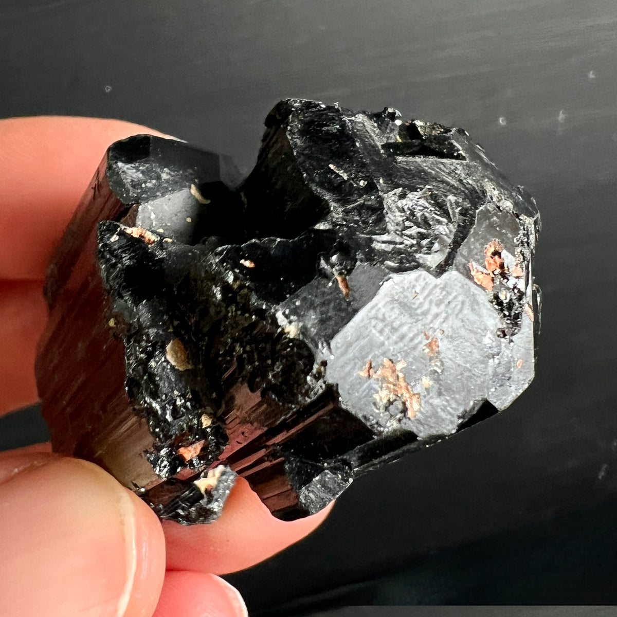 Schwarzer Turmalin Rohkristall mit glänzenden Spaltflächen, silbergrauem Schimmer und kupferfarbenen Einschlüssen | Happy Minerals