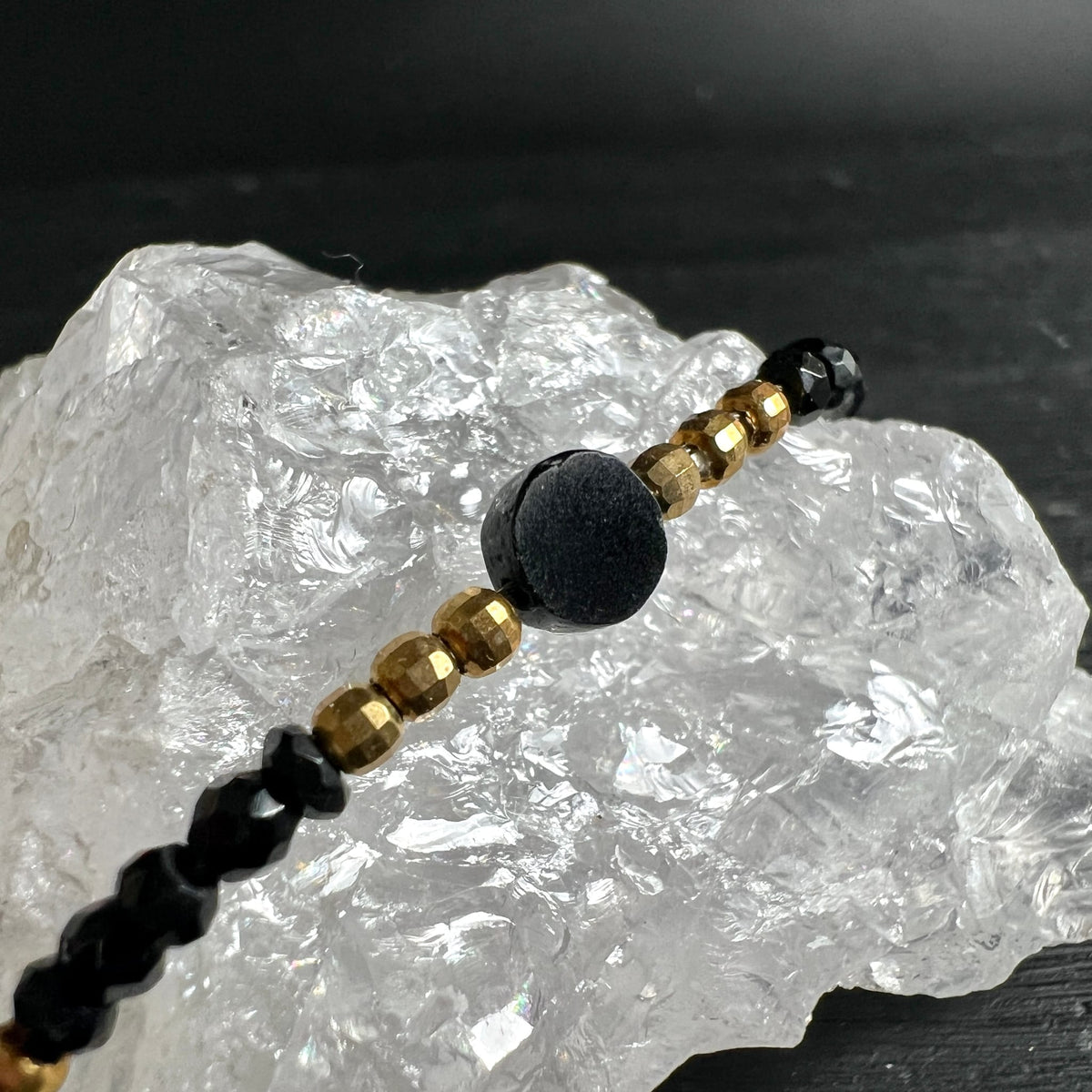 Spinell | Makroaufnahme | goldene Perlen | schwarze Kugel | Bergkristall | Happy Minerals