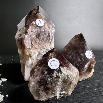 Drei rohe Kristallspitzen A B C mit rauchbraun-violetten Zonen, klaren Facetten und milchigen Einschluessen | Happy Minerals