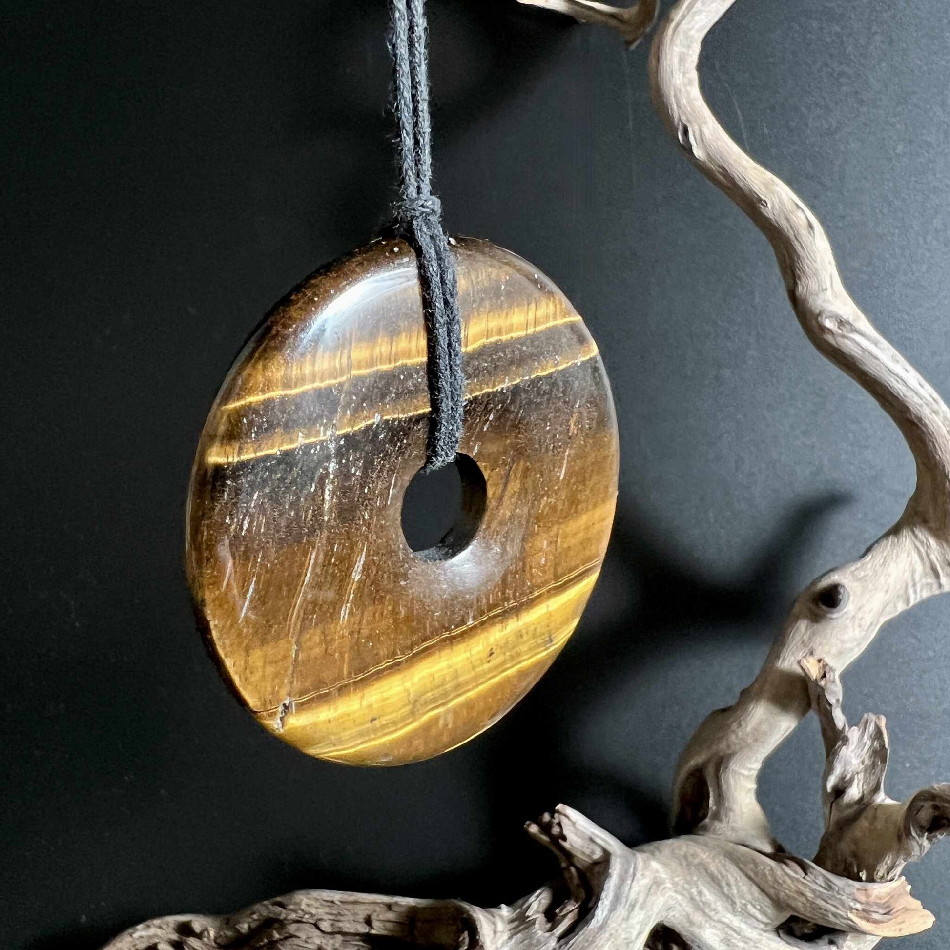 Tigerauge Donut Anhänger mit goldenem Chatoyance-Effekt an Treibholz