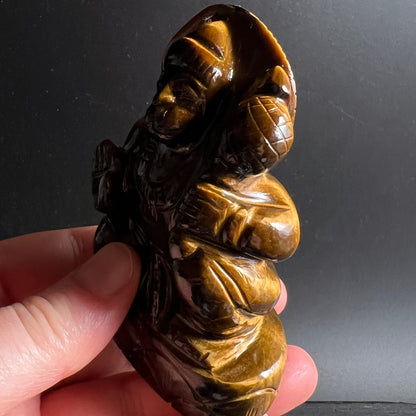 Tigerauge Hanuman | Rücken-Seitenansicht | großer Sack | warm goldbraun | Hand hält Unikat | Happy Minerals